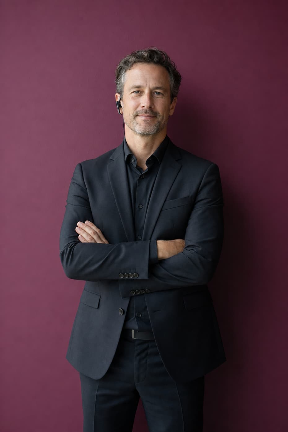 An experienced event planner with arms folded